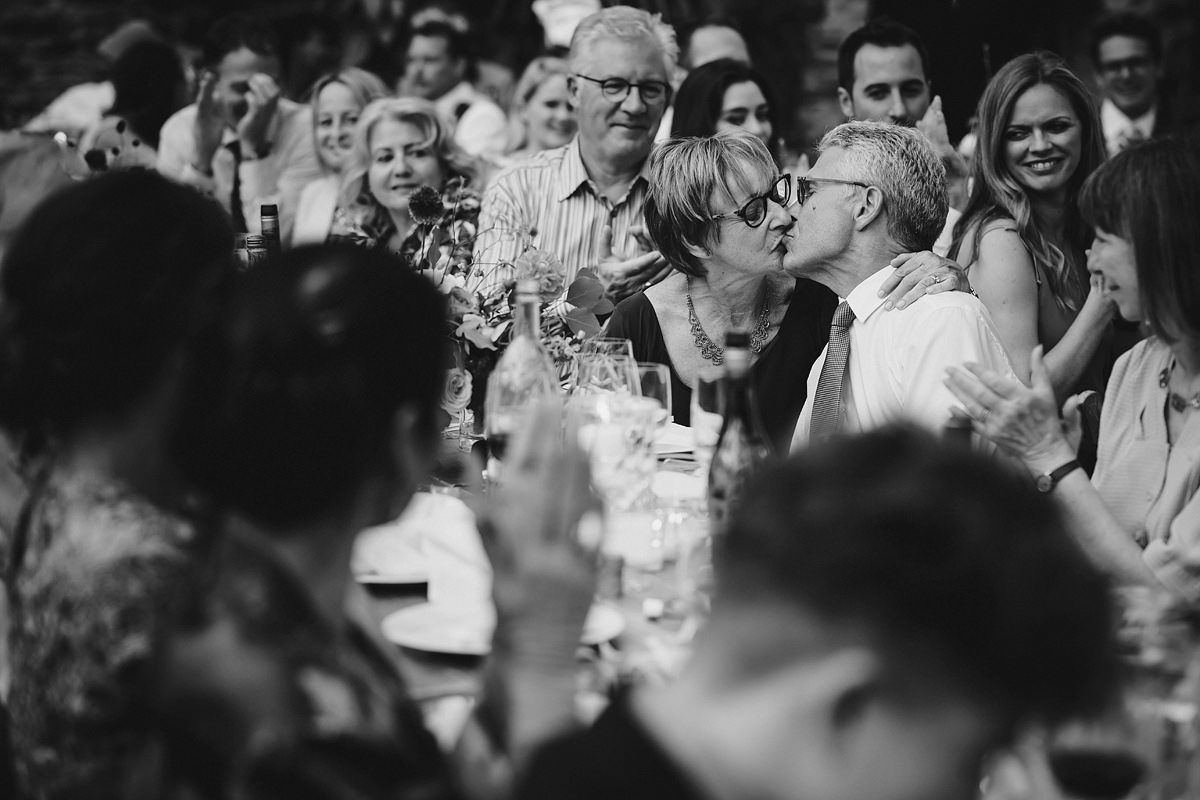 Guests kissing during speeches