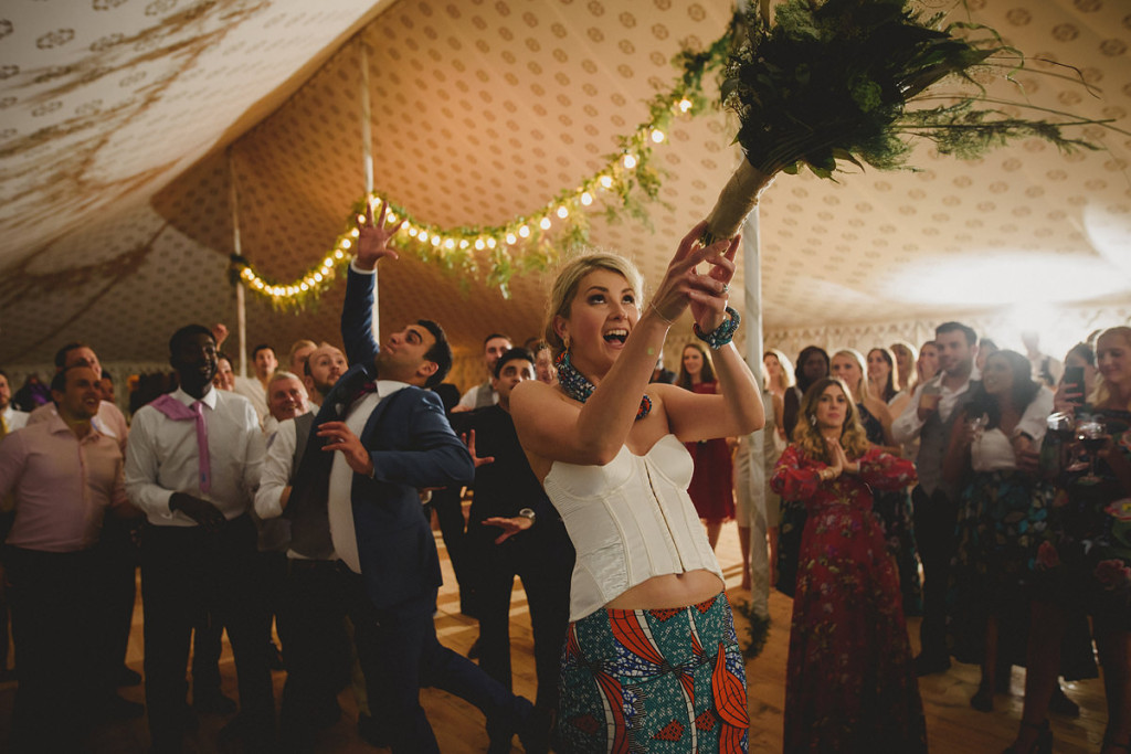Bride throwing bouquet at Pencarrow House