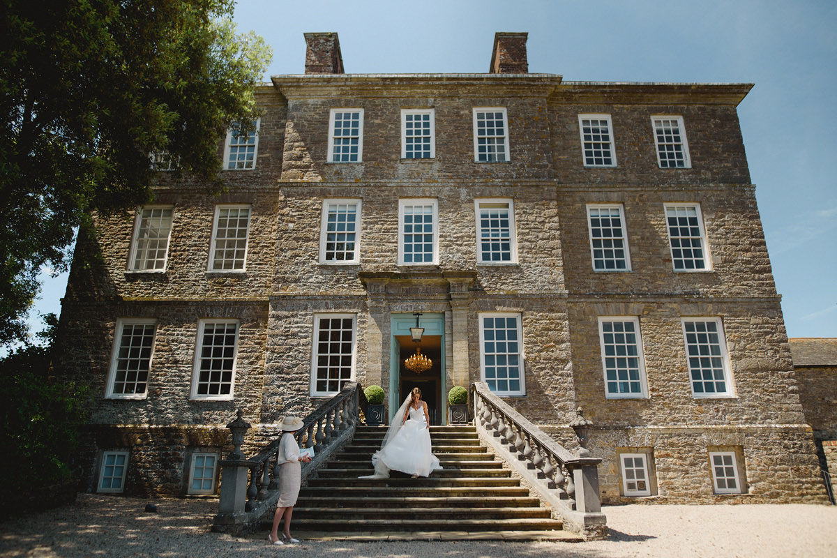 Bride walking down stairs at Kingston Estate