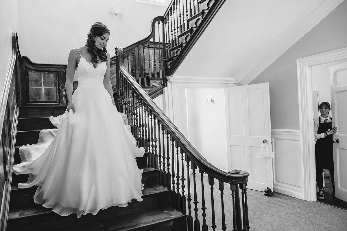 Bride walking down stairs in wedding dress